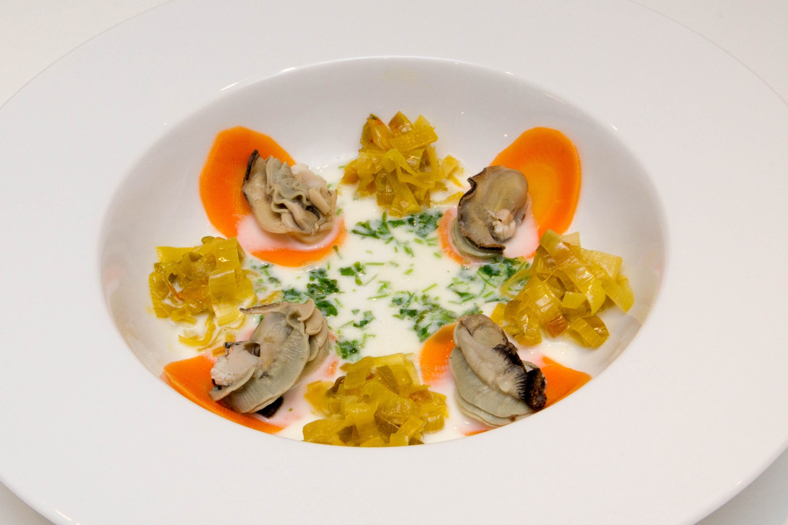 Poached Oyster with Safron Leek, carrot and creme parsley